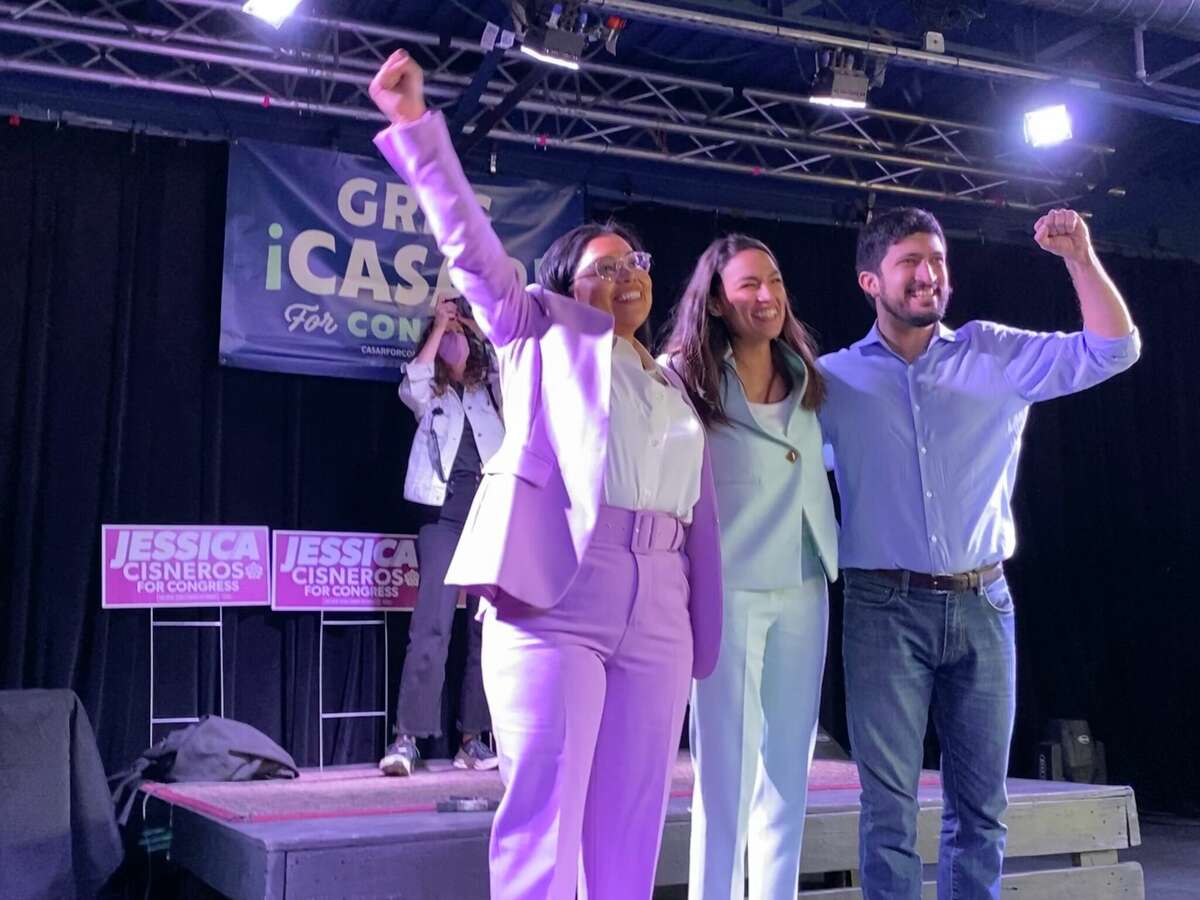 Jessica Cisneros, AOC and Greg Casar wave to the crowd at their voting rally event at Paper Tiger in San Antonio on Saturday, February 12. 