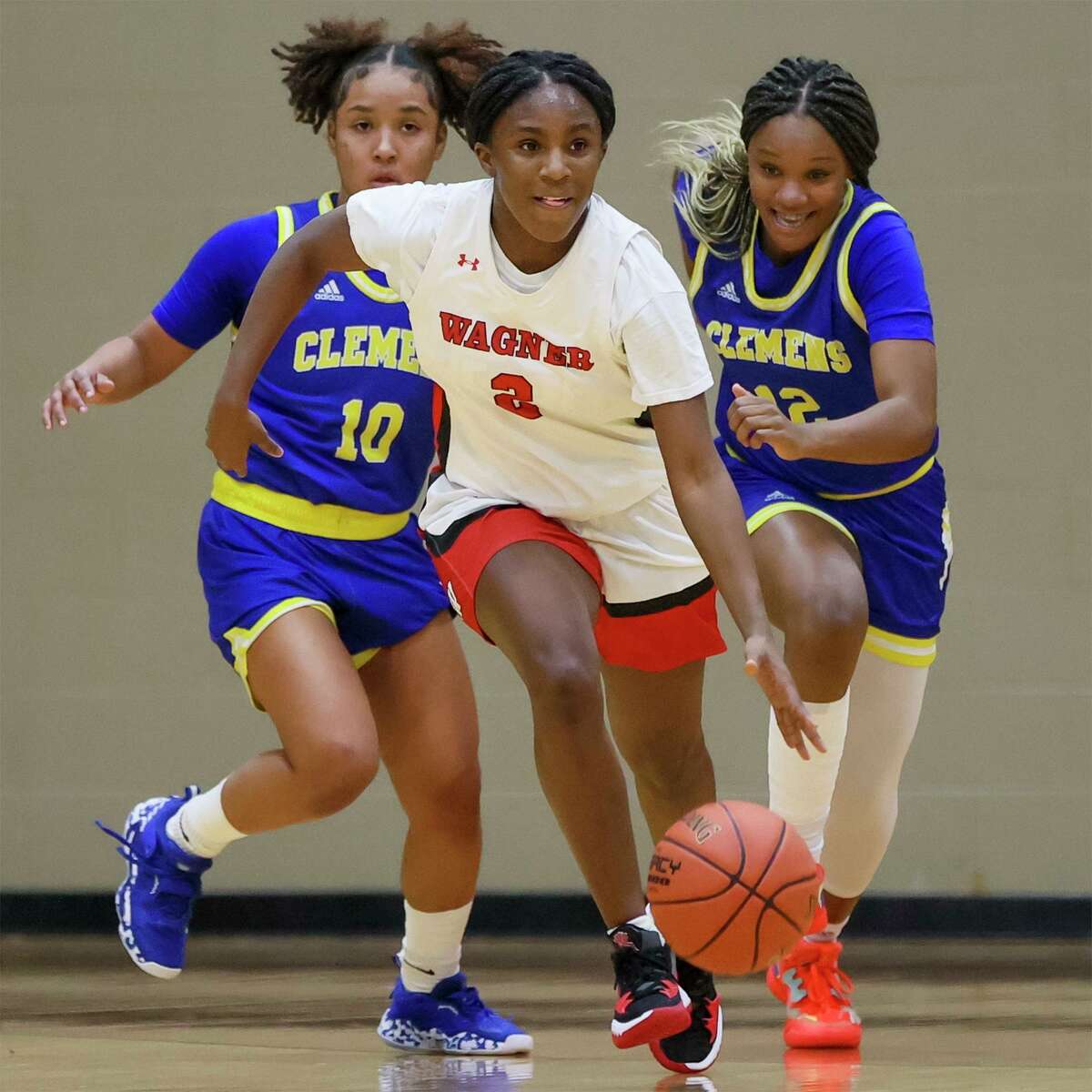 Wagner's La Sneed races past Clemens Deja Hinson, left, and Aysia Proctor during their District 27-6A girls basketball game at Wagner on Tuesday, Feb. 8, 2022. Wagner claimed the district title with a 78-45 victory over Clemens.