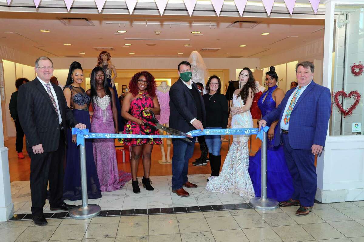 Karlene Lindsay-Worrell opens Karlene Lindsay Desings at the Connecticut Post Mall, which she said was the right choice. Pictured from left to right are Ken Sterba, general manater of the CT Post Mall; two models; Lindsay-Worrell, Ben Blake, Mayor; Kathy Kennedy, State Representative (R-119); two models and Simon McDonald, director of Milford Regional Chamber of Commerce.