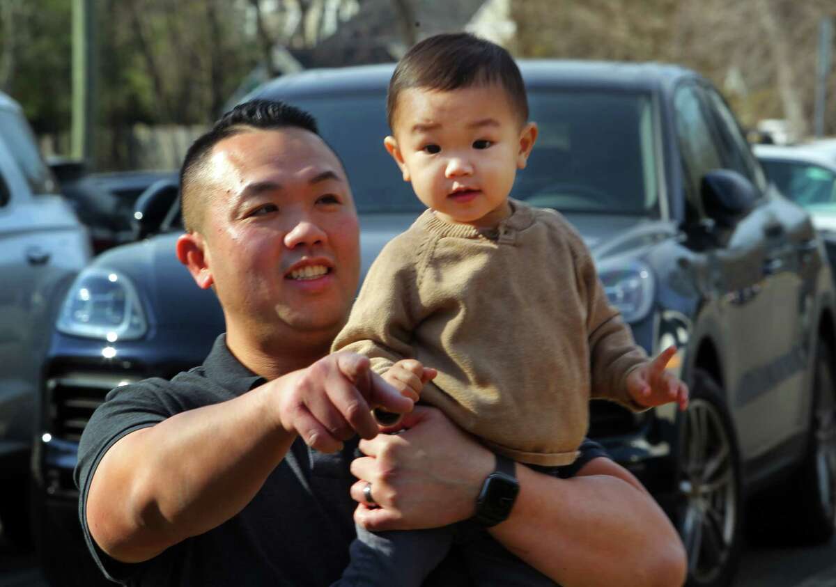 Nam Kenji carries his son Phu, 20 months, during a Lunar New Year celebration at Cos Cob Library in Greenwich, Conn., on Saturday February 12, 2022. The event featured crafts, a Mandarin Storytime and a demonstration of a southern Chinese Martial Art called Wing Tsun by members of the Club Kung Fu.