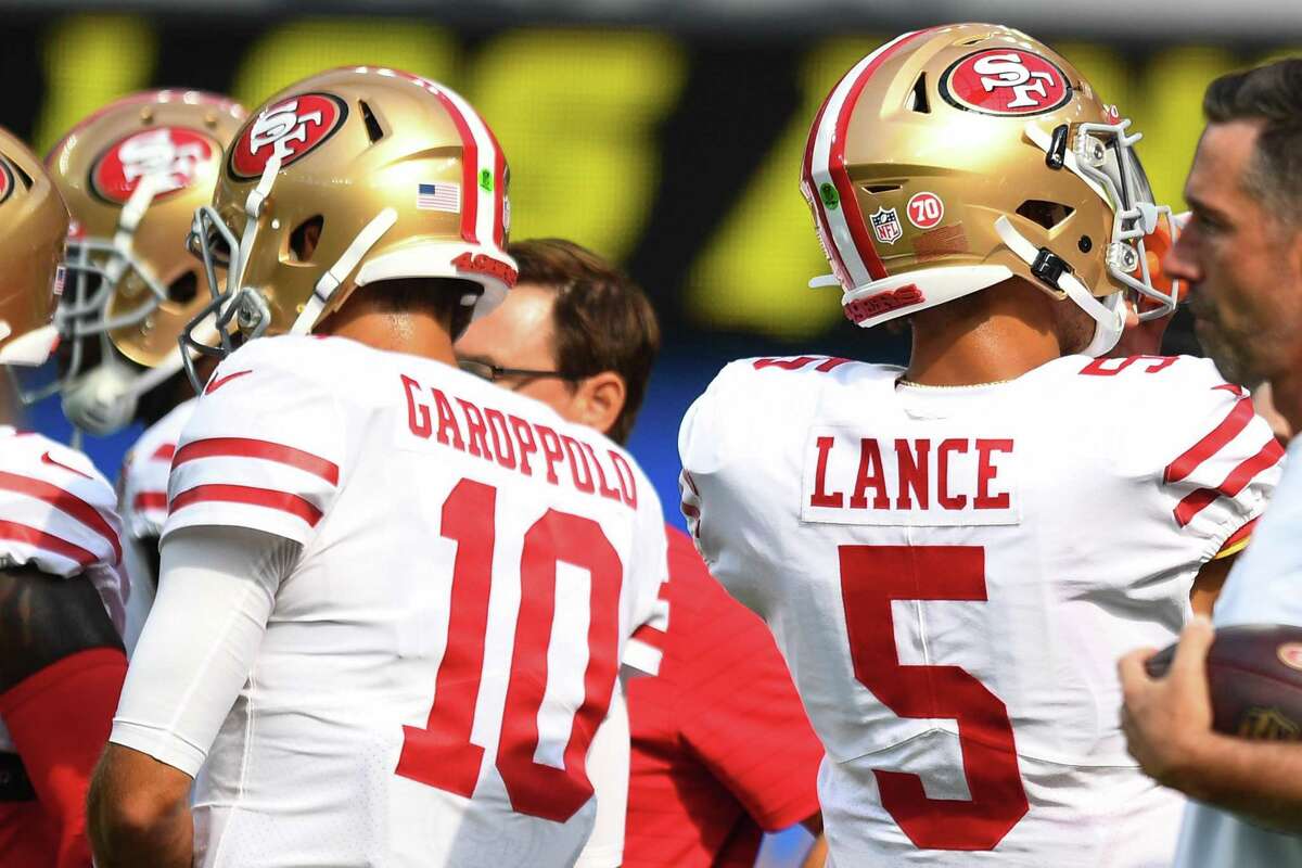 INGLEWOOD, CA - AUGUST 22: San Francisco 49ers quarterback Jimmy Garoppolo (10) and quarterback Trey Lance (5) look on before the NFL preseason game between the San Francisco 49ers and the Los Angeles Chargers on August 22, 2021, at SoFi Stadium in Inglewood, CA. (Photo by Brian Rothmuller/Icon Sportswire via Getty Images)