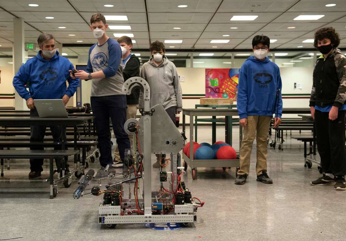 Students and teachers test a robot during robotics club at Albany High School to use in competitions on Thursday, Feb. 10, 2022 in Albany, N.Y. Albany High School is entering the first Robotics competition with assistance from National Grid.