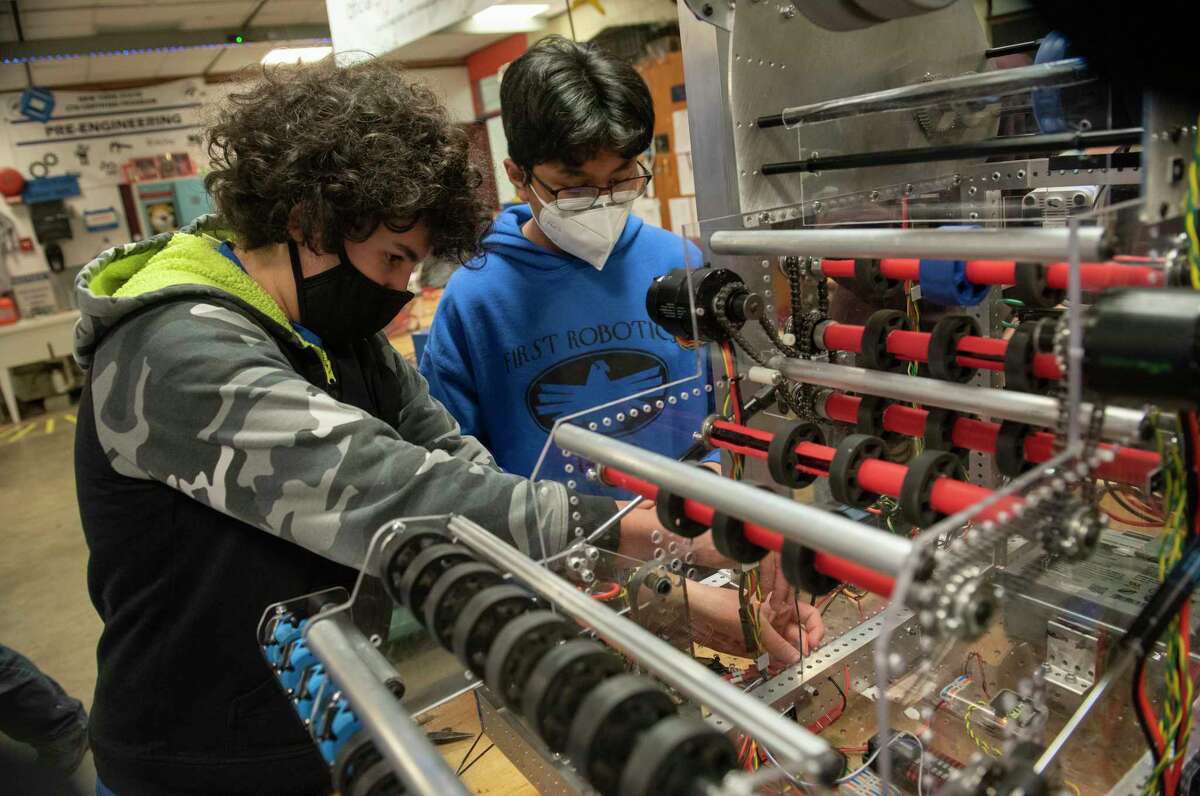 Freshman Makki Gally, left, and sophomore Saugat Shahat work on the robot during robotics club at Albany High School to use in competitions on Thursday, Feb. 10, 2022 in Albany, N.Y. Albany High School is entering the first Robotics competition with assistance from National Grid.