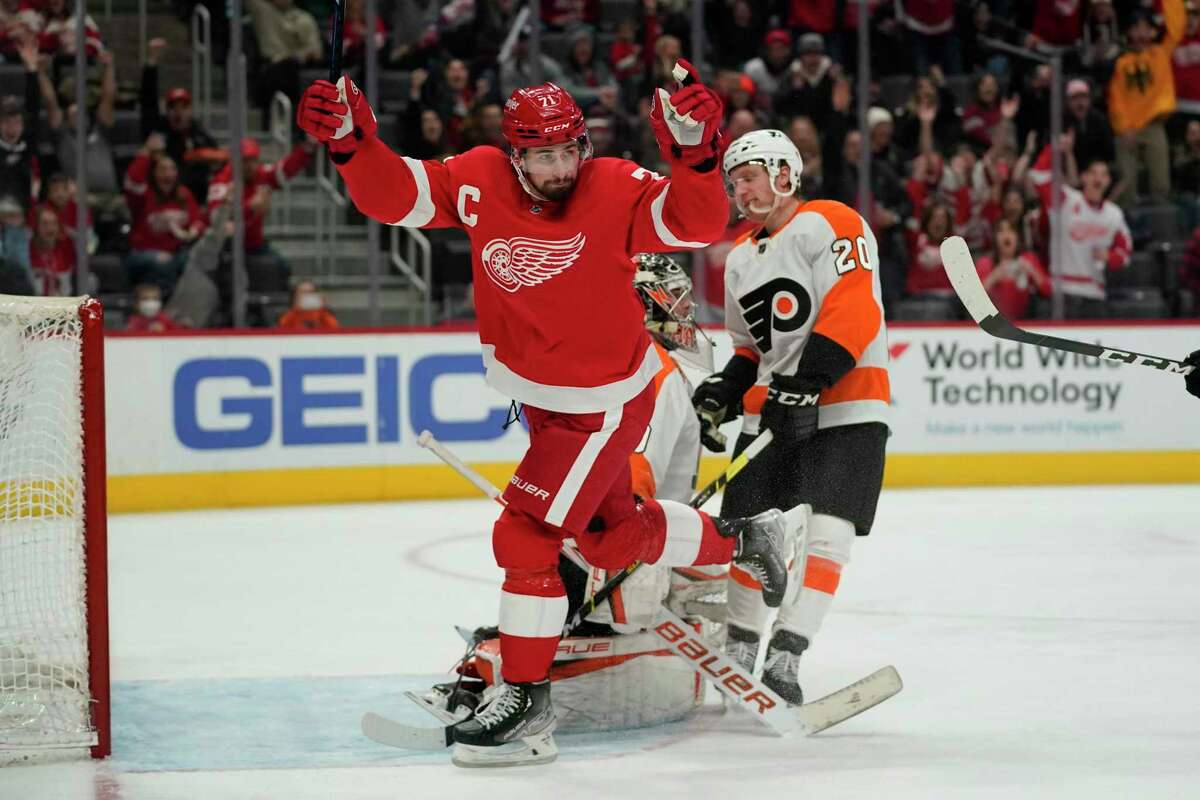 Detroit Red Wings center Dylan Larkin reacts to a Filip Zadina goal against the Philadelphia Flyers in the second period of an NHL hockey game Saturday, Feb. 12, 2022, in Detroit. (AP Photo/Paul Sancya)