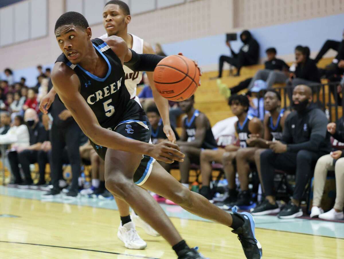 Shadow Creek’s Shawn Jones (5) drives past Pearland’s Charles Clark (4) during game action at Turner High School in Pearland on Saturday, Feb. 12, 2022. Shadow Creek won the game in double overtime 37-35.