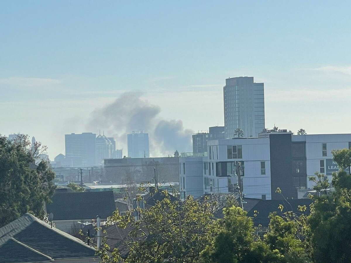 Smoke plumes into the sky as Oakland firefighters battled a boat fire located on a trailer in the area of Sixth and Castro streets on Saturday afternoon, according to Oakland fire officials.