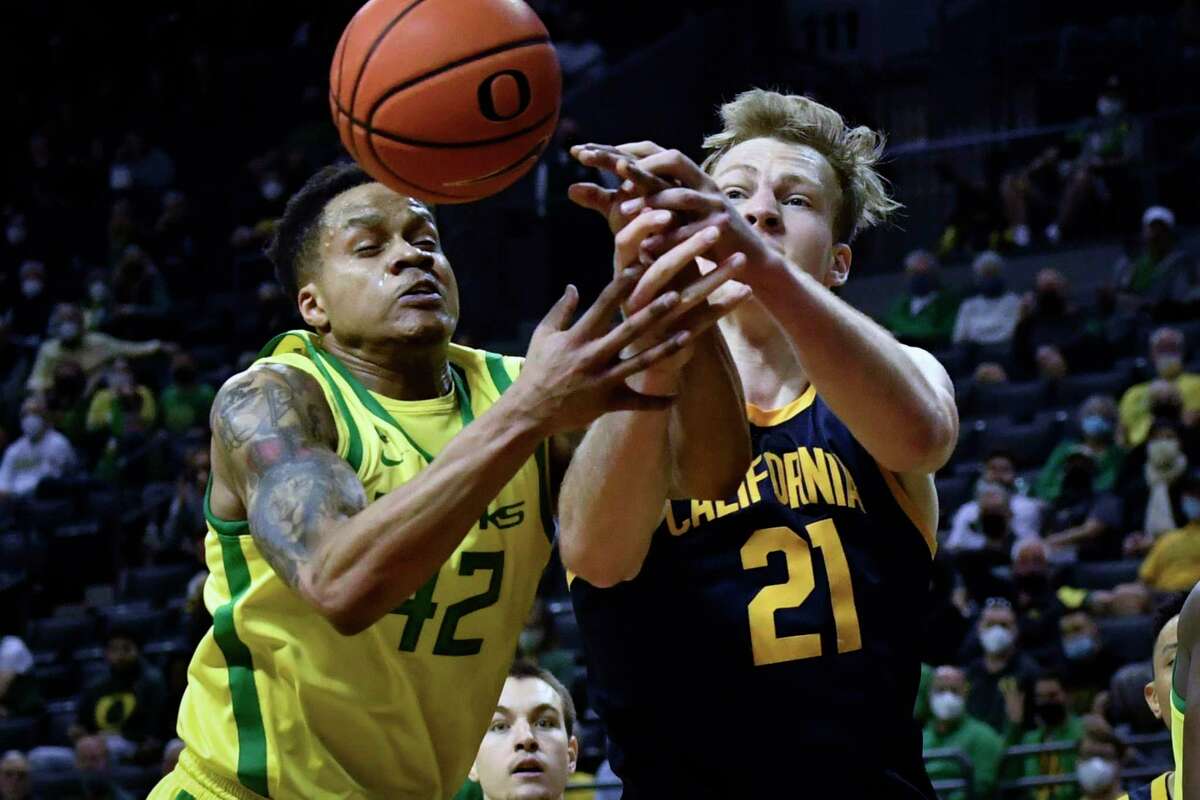 Oregon guard Jacob Young (42) and California forward Lars Thiemann (21) battle for a loose ball during the first half of an NCAA college basketball game Saturday, Feb. 12, 2022, in Eugene, Ore. (AP Photo/Andy Nelson)