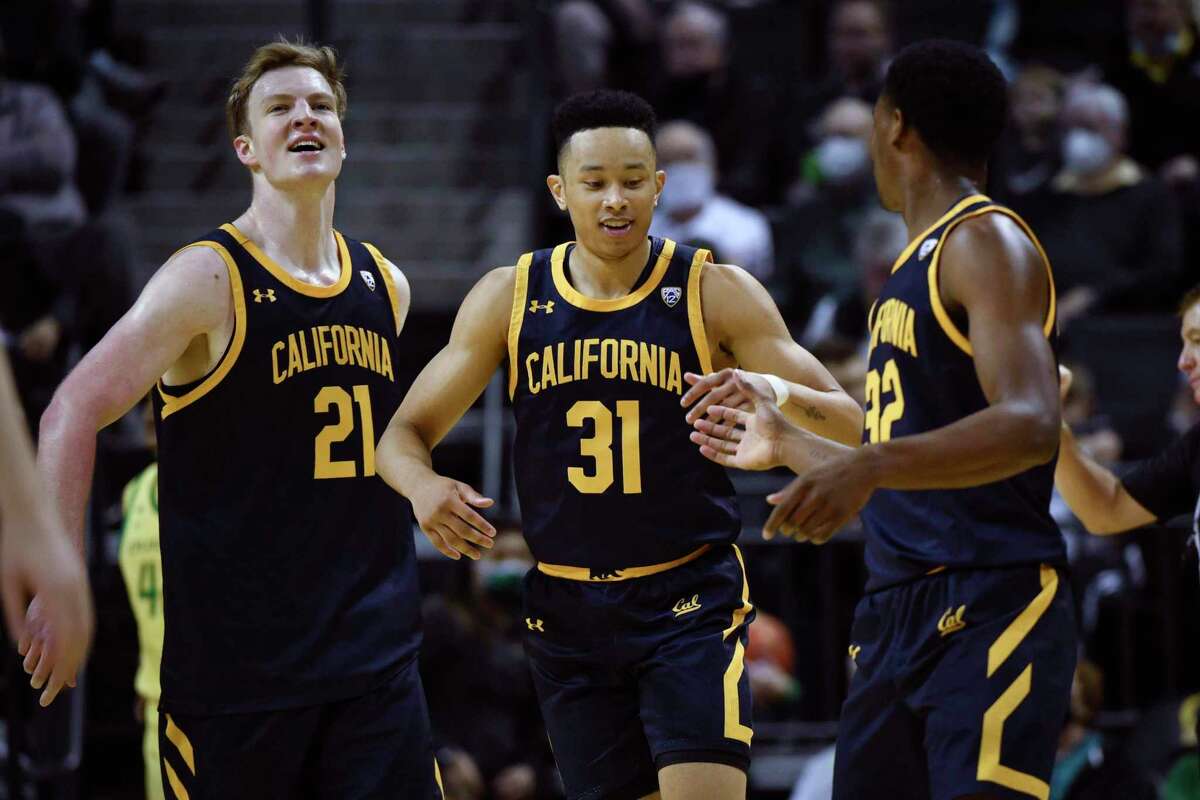 California forward Lars Thiemann (21), California guard Jordan Shepherd (31) and California guard Jalen Celestine (32) celebrate after taking a big lead over Oregon during the first half of an NCAA college basketball game Saturday, Feb. 12, 2022, in Eugene, Ore. (AP Photo/Andy Nelson)