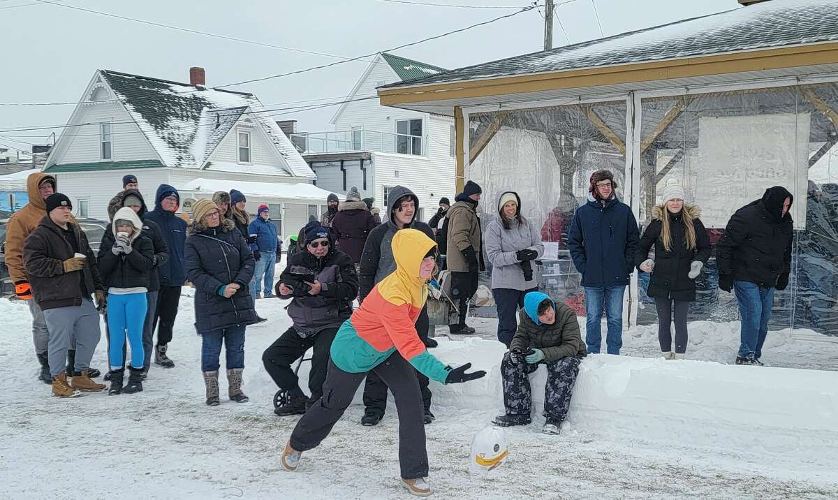 A young bowler lets a frozen turkey fly, aiming at frozen 2-liter bottles at the end of the lane at a previous Winterfest in Beulah. 