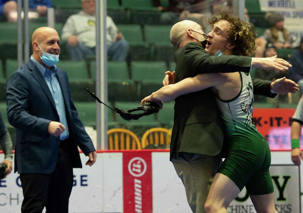 Shenendehowa's Ayden Robles embraces one of his coaches following his victory over Burnt Hills-Ballston Lake's Liam Carlin in the 128-lb. weight class match at Section II wrestling championships on Saturday, Feb. 12, 2022 in Glens Falls, N.Y. (Jenn March, Special to the Times Union)