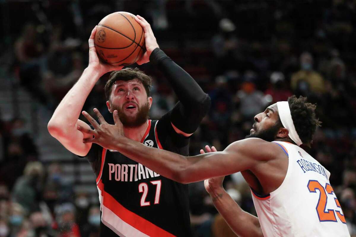 Portland Trail Blazers center Jusuf Nurkic shoots over New York Knicks center Mitchell Robinson during the first half of an NBA basketball game in Portland, Ore., Saturday, Feb. 12, 2022. (AP Photo/Amanda Loman)
