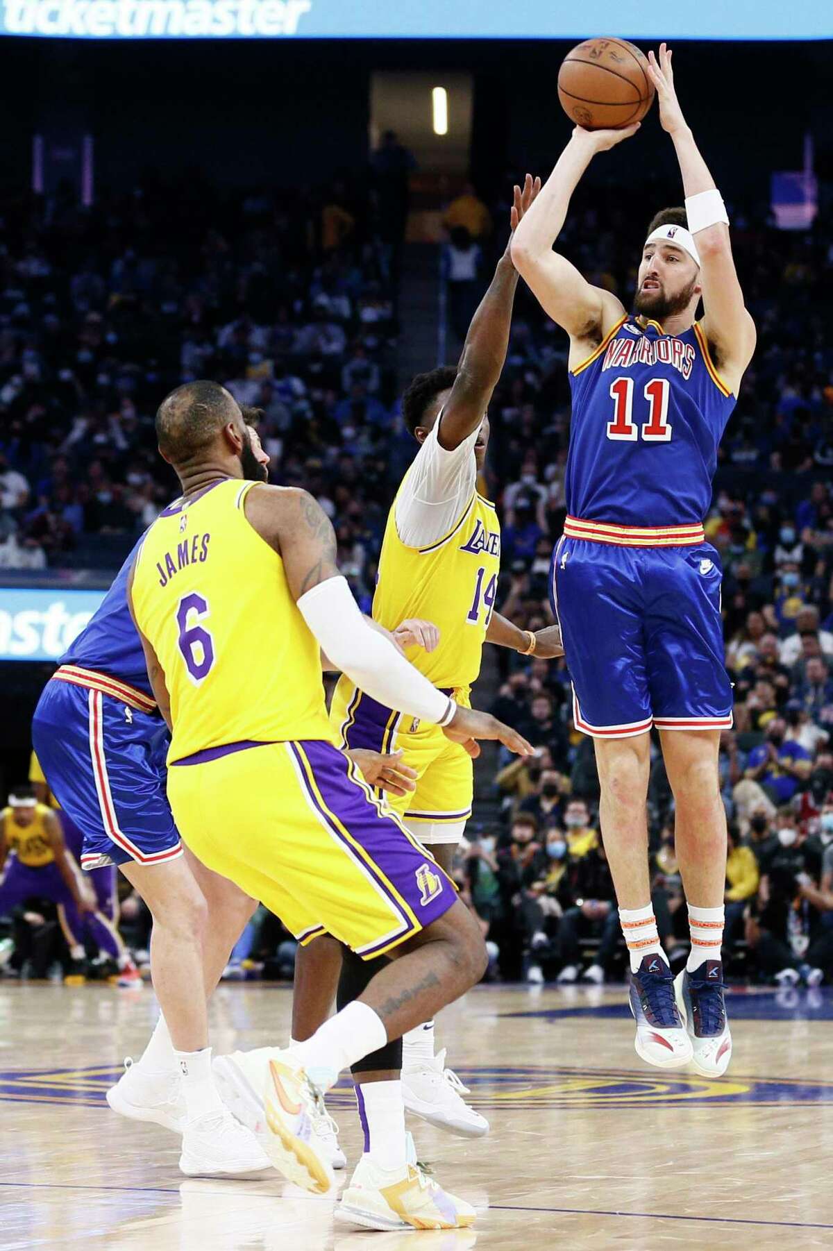 Golden State Warriors guard Klay Thompson (11) attempts a three-point shot against the Los Angeles Lakers in the first half of an NBA game at Chase Center, Saturday, Feb. 12, 2022, in San Francisco, Calif.