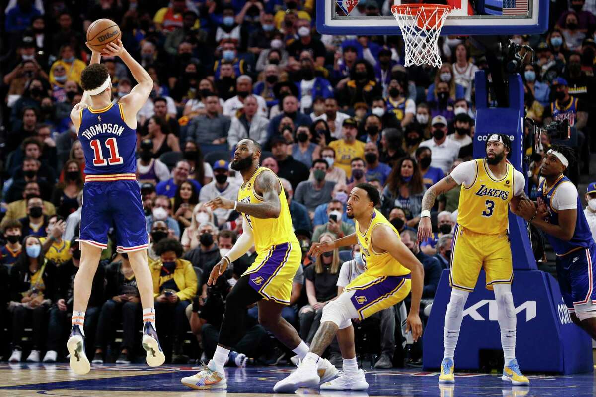Golden State Warriors guard Klay Thompson (11) scores a two-point shot against Los Angeles Lakers forward LeBron James (6) in the second half of an NBA game at Chase Center, Saturday, Feb. 12, 2022, in San Francisco, Calif. The Warriors won 117-115.