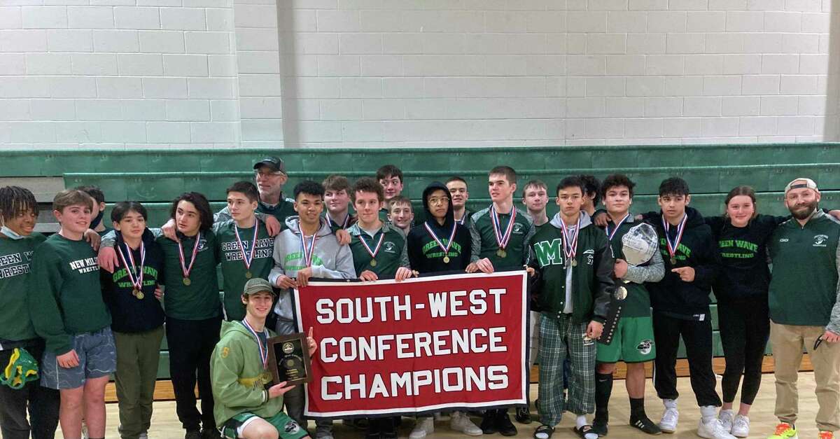The New Milford wrestling team celebrates after winning the SWC tournament. The Green Wave has won 13 of the past 15 SWC tournament titles.