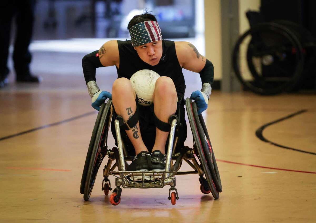 Timothy Vixay moves the ball up the court during tryouts for the inaugural United States Low-Point Wheelchair Rugby Team on Sunday, Feb. 13, 2022, at the West Gray Adaptive Recreation Center in Houston.