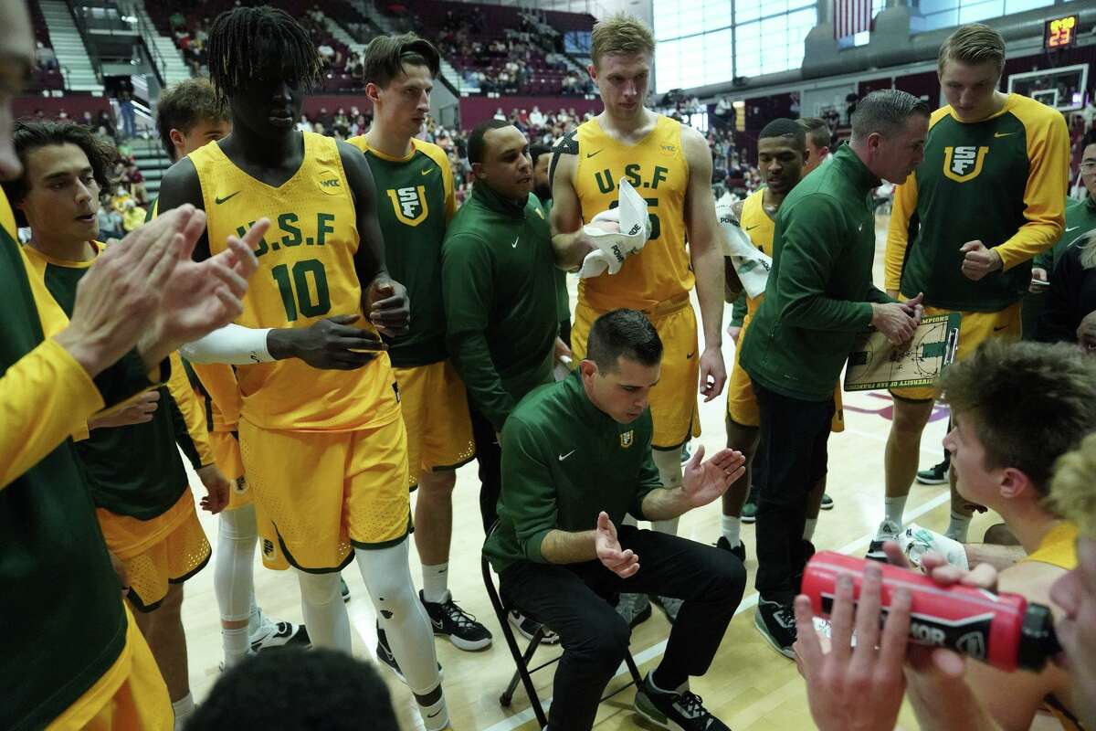 Head coach Todd Golden talks to his USF players during the Dons' 74-58 win at Santa Clara on Saturday.