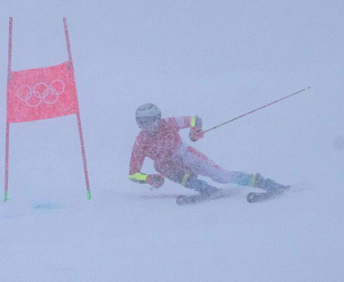 Marco Odermatt of Switzerland skis through poor visibility and fresh powder in the giant slalom.