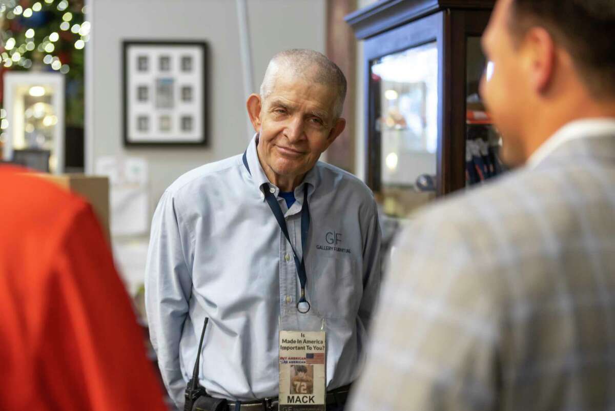 Mattress Mack” Jim McIngvale, listens as representative from Operation Finally Home and the Howard Hughes Corporation tell them about U.S. Army Staff Sergeant Stephen Netzley at Gallery Furniture, Thursday, June 17, 2021, in Houston.