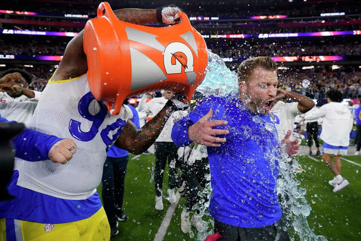 Los Angeles Rams defensive end A'Shawn Robinson, left, pours Gatorade over Los Angeles Rams head coach Sean McVay after the Rams defeated the Cincinnati Bengals NFL Super Bowl 56 football game Sunday, Feb. 13, 2022, in Inglewood, Calif. (AP Photo/Marcio Jose Sanchez)