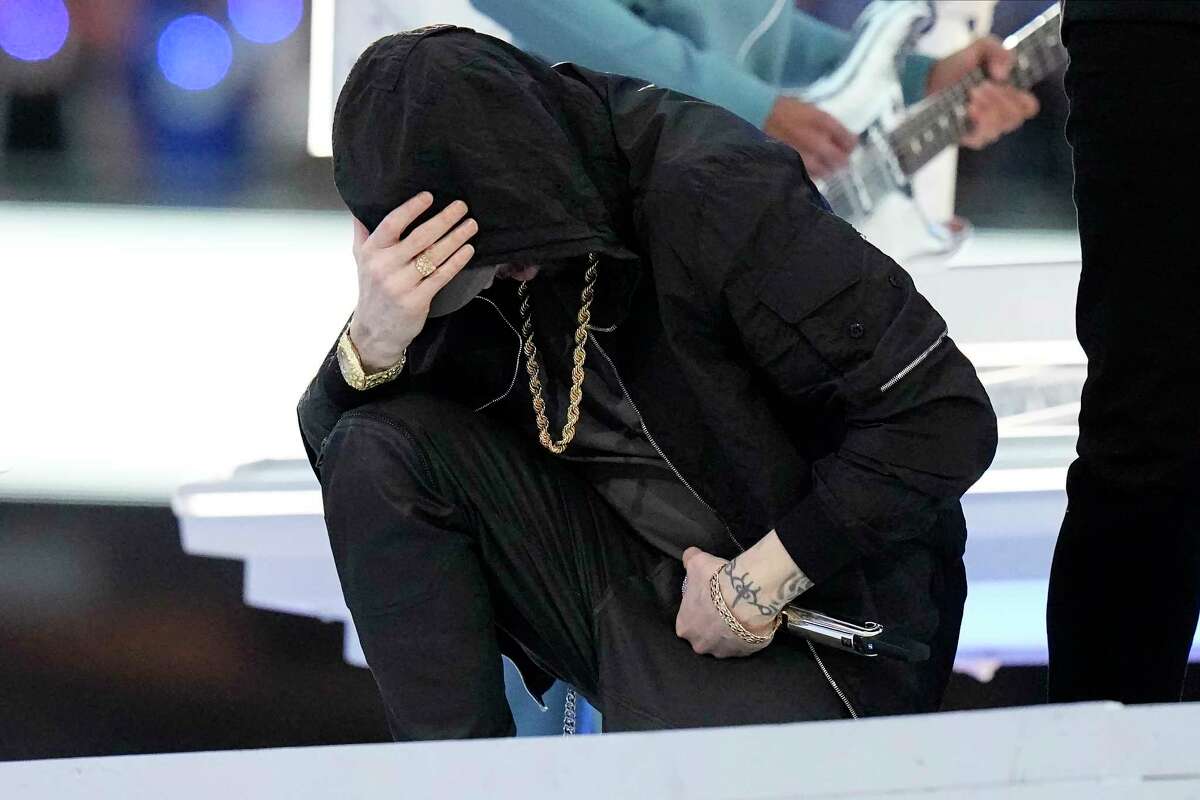 Eminem kneels down during the halftime performance at the NFL Super Bowl 56 football game between the Los Angeles Rams and the Cincinnati Bengals Sunday, Feb. 13, 2022, in Inglewood, Calif.