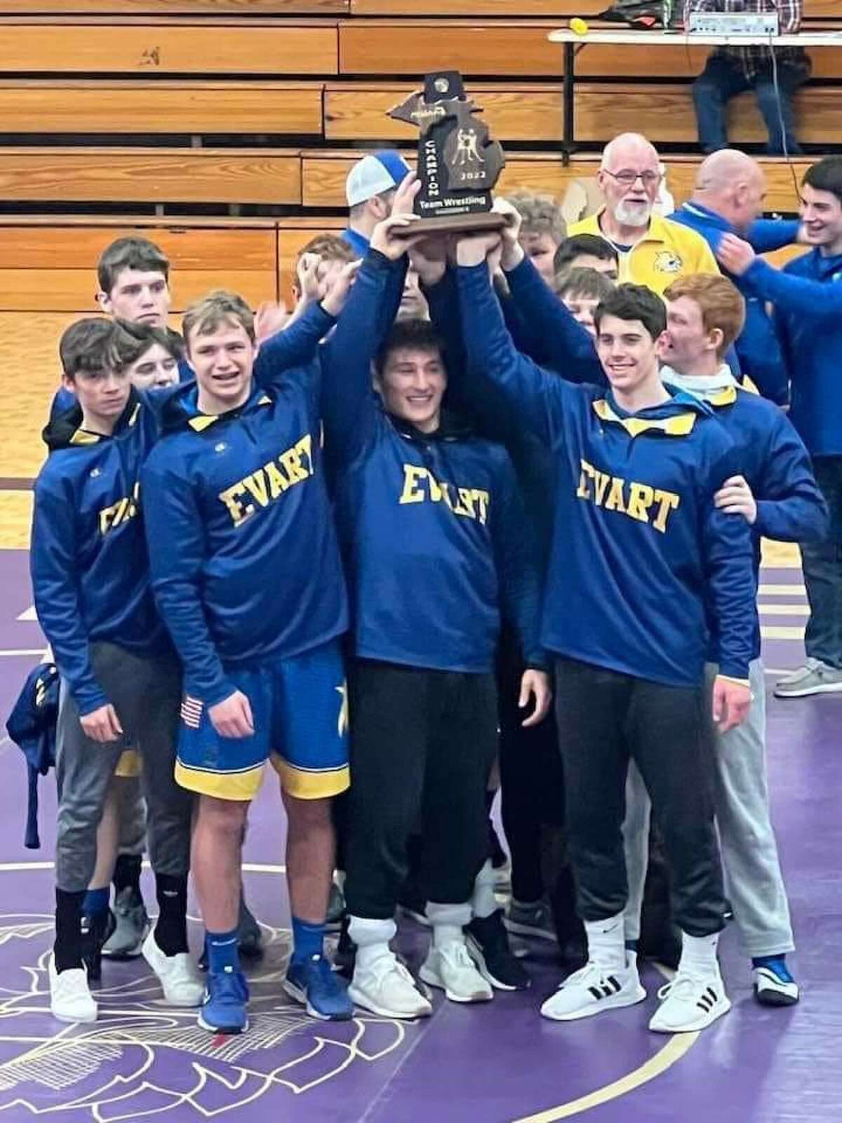 Evart wrestlers celebrate the district title.