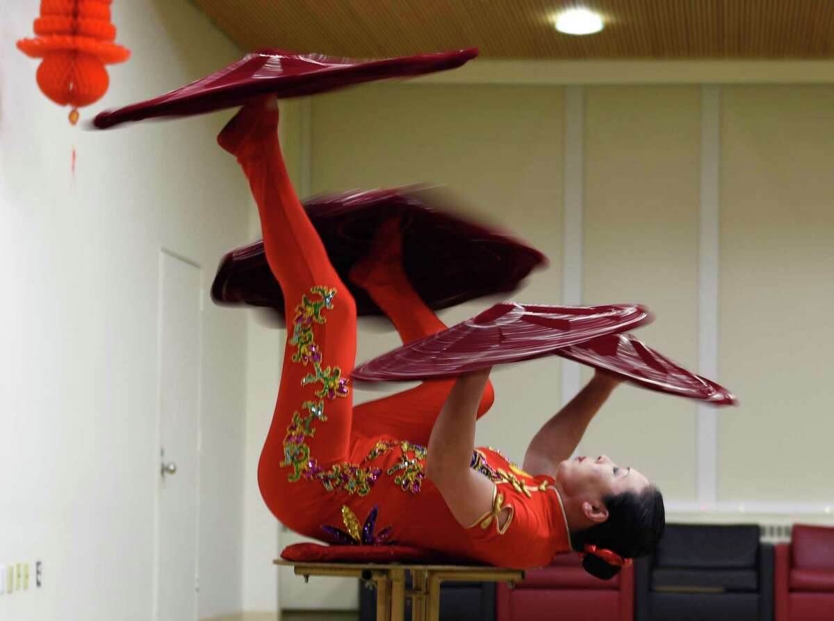 Chinese acrobat Li Liu performs during the Lunar New Year celebration at the Ferguson Library in Stamford, Conn. Sunday, Feb. 13, 2022. Presented in partnership with Traditional Martial Arts and Club Kung Fu, the event celebrated the Year of the Tiger with activities including a Chinese acrobatic performance and Tae Kwon Do and Wing Tsun Martial Arts demonstrations.