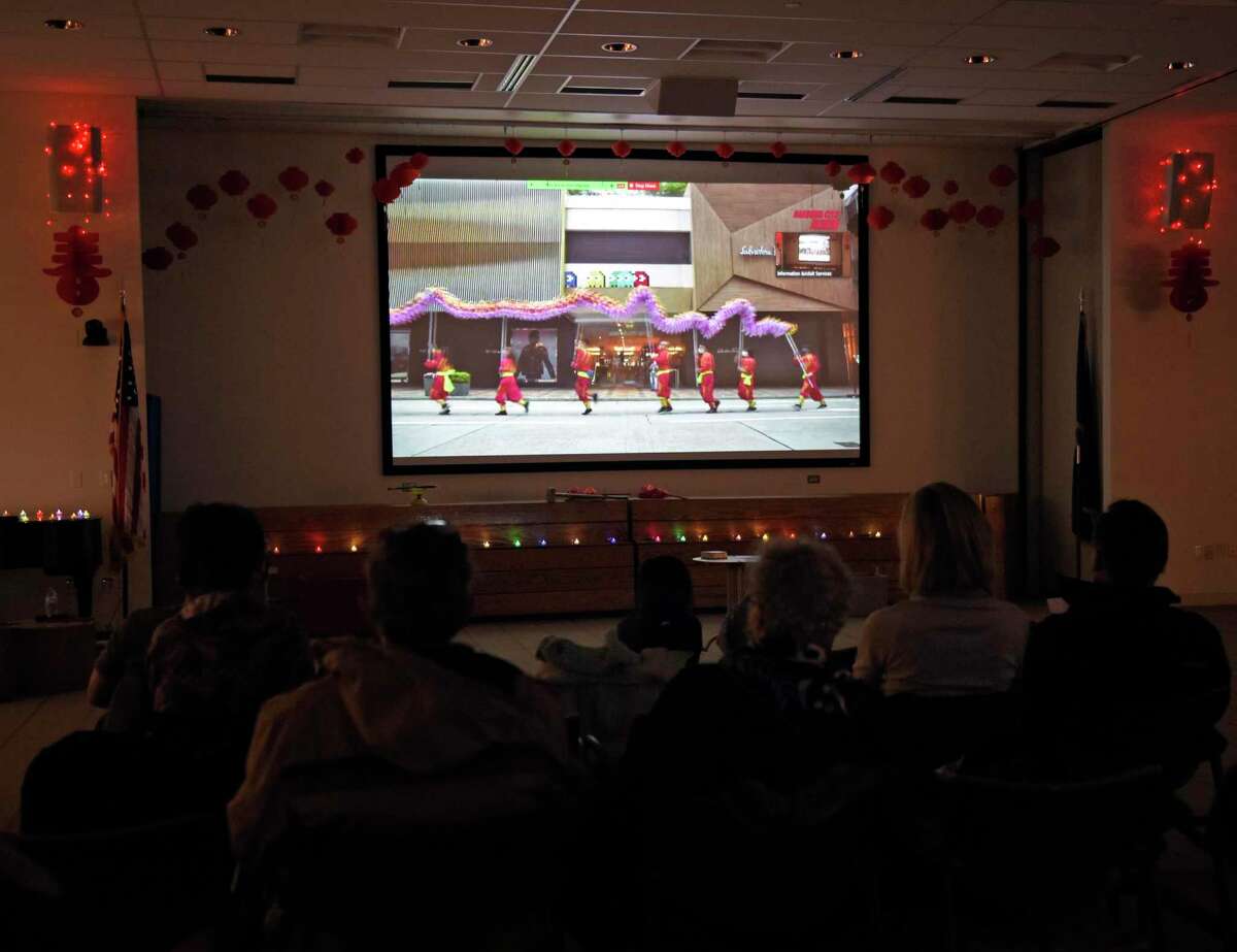 A video plays during the Lunar New Year celebration at the Ferguson Library in Stamford, Conn.  Sunday, Feb.  13, 2022. Presented in partnership with Traditional Martial Arts and Club Kung Fu, the event celebrated the Year of the Tiger with activities including a Chinese acrobatic performance and Tae Kwon Do and Wing Tsun Martial Arts demonstrations.