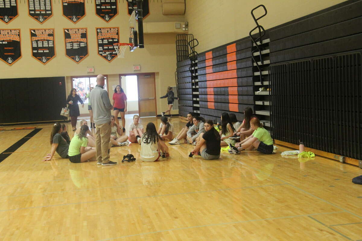 The Harbor Beach Lady Pirates discussing what's happening at practice.