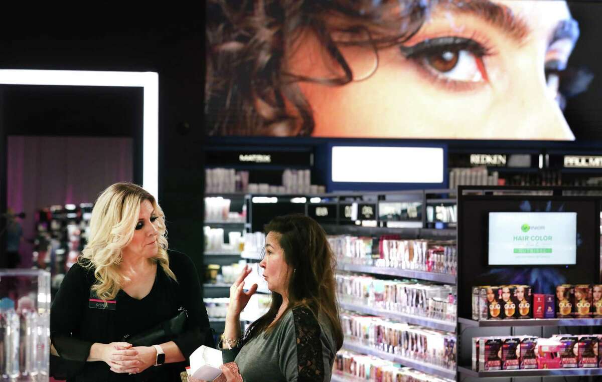 In this 2019 photo, Kimberly Sczech, right, asks Sonia Lujan of H-E-B a makeup question as the store holds a soft opening of Beauty, their new cosmetics department at the H-E-B Plus! on Evans Road.