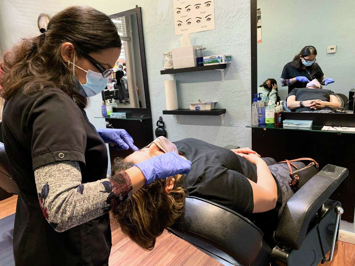 Bonita Brows Bar owner Mandy Koirala (left) works on the eyebrows of Clara Marin at Koirala's small salon inside the H-E-B Plus! on Potranco Road near Loop 1604. Marin went in for an eyebrows cleanup before grocery shopping.