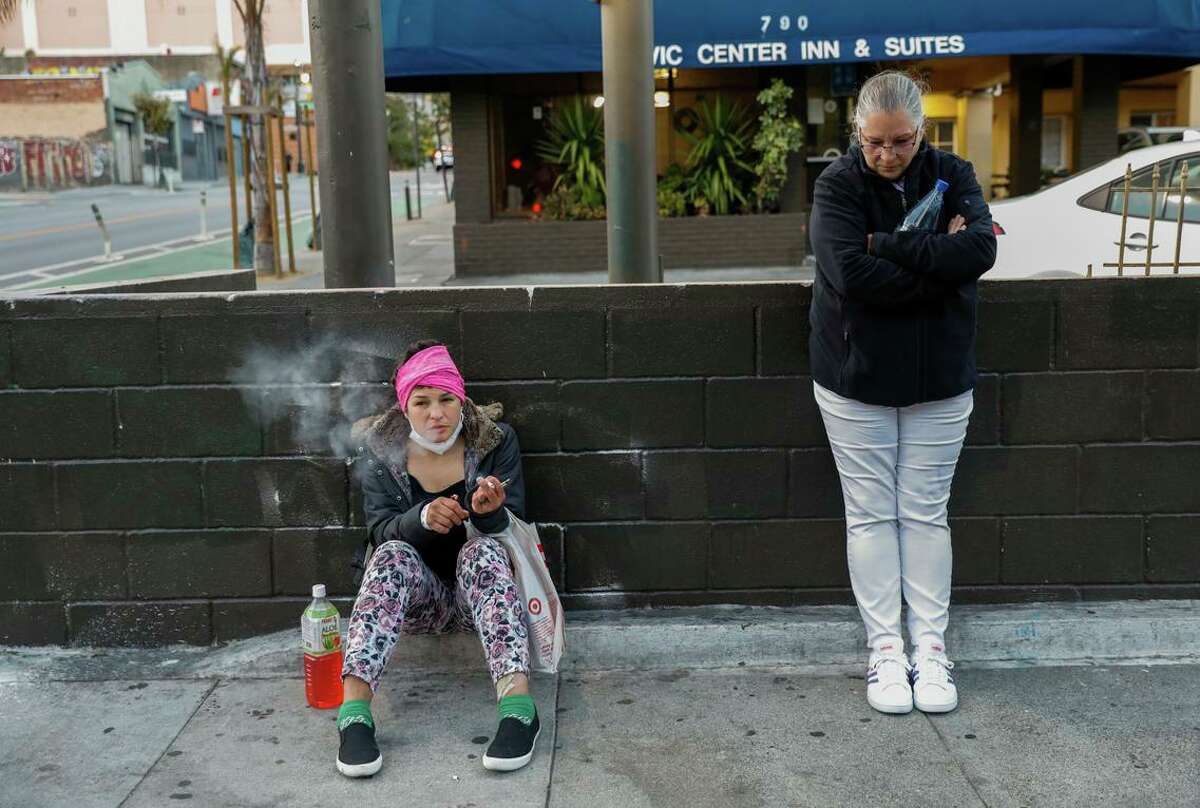Jessica smokes a cigarette with mom Laurie on Ellis Street in the Tenderloin.  Laurie tried to stay positive, but she sometimes found herself reflecting on her regrets about her as a mom.