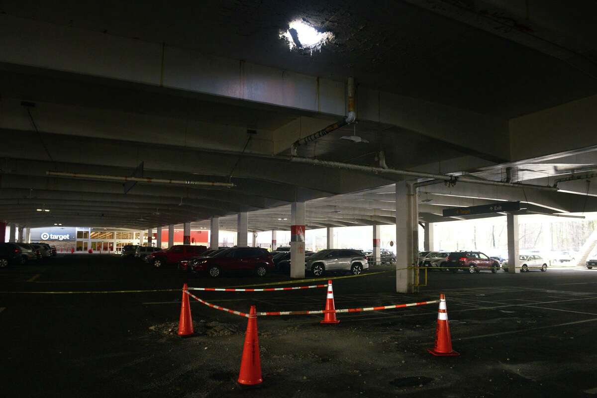 A hole in one of the elevated parking lots, seen from a ground level parking lot at the Westfield Trumbull shopping mall, in Trumbull, Conn. Feb. 14, 2022.