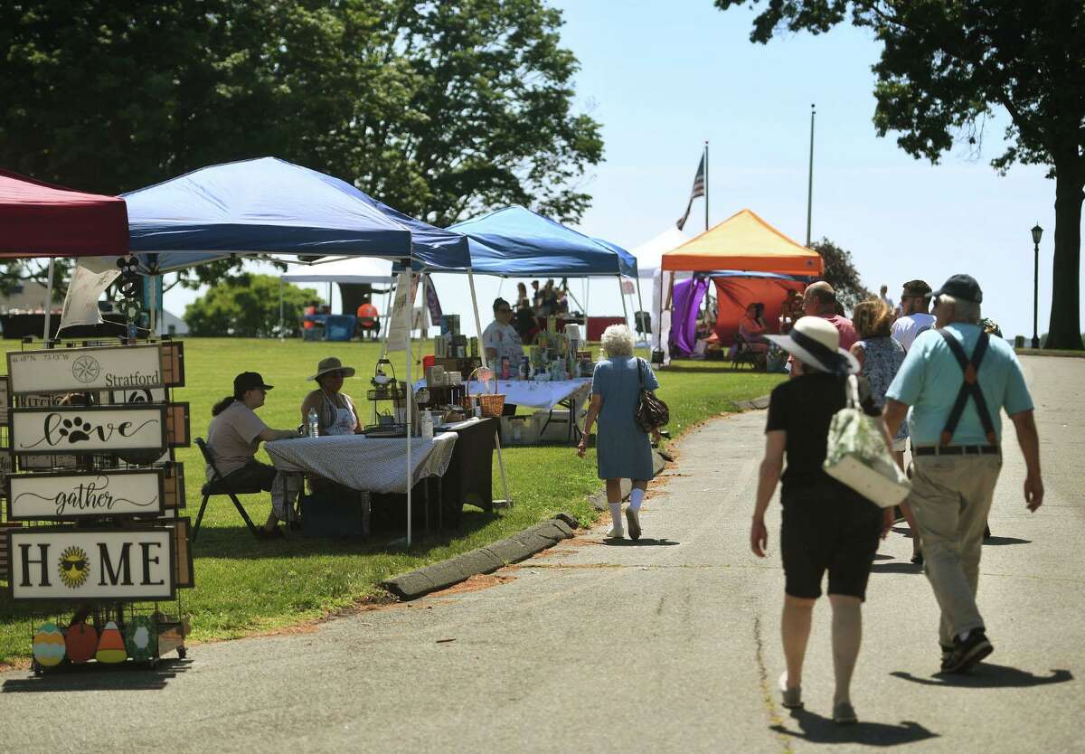 Visitors check out the booths at the Shakespeare Market on the Shakespeare Theater property in Stratford, Conn. on Sunday, June 20, 2021.
