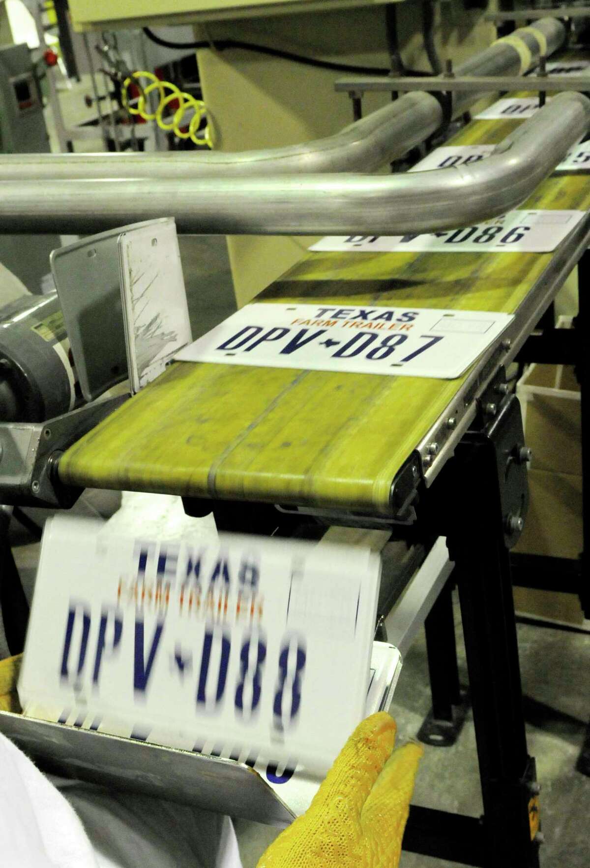 **ADVANCE FOR SUNDAY, APRIL 19 **In this March 31, 2009 photo, new Texas license plates slide off a conveyor belt at the Wynne Farm Unit of the Texas Department of Criminal Justice in Huntsville, Texas. The plate plant turns out vehicle license plates by the thousands daily. (AP Photo/Pat Sullivan)