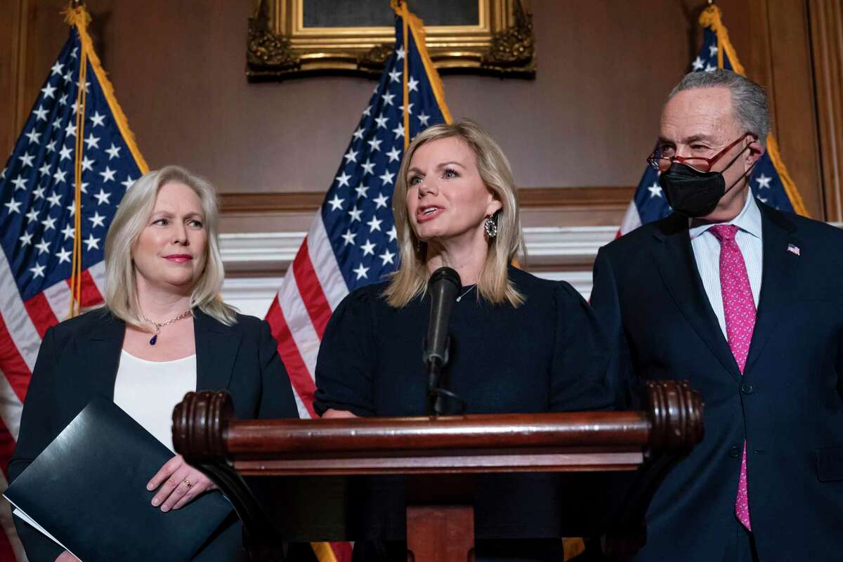 Former Fox News anchor Gretchen Carlson, center, joins Sen. Kirsten Gillibrand, D-N.Y., left, and Senate Majority Leader Chuck Schumer, D-N.Y., after Congress gave final approval to legislation guaranteeing that people who experience sexual harassment at work can seek recourse in the courts, during a news conference at the Capitol in Washington, Thursday, Feb. 10, 2022. Since her 2016 sexual harassment lawsuit against then Fox News Chairman and CEO Roger Ailes, Carlson has worked to ban non-disclosure agreements and forced arbitration clauses in employment agreements to prevent victims of sexual harassment from being silenced. (AP Photo/J. Scott Applewhite)