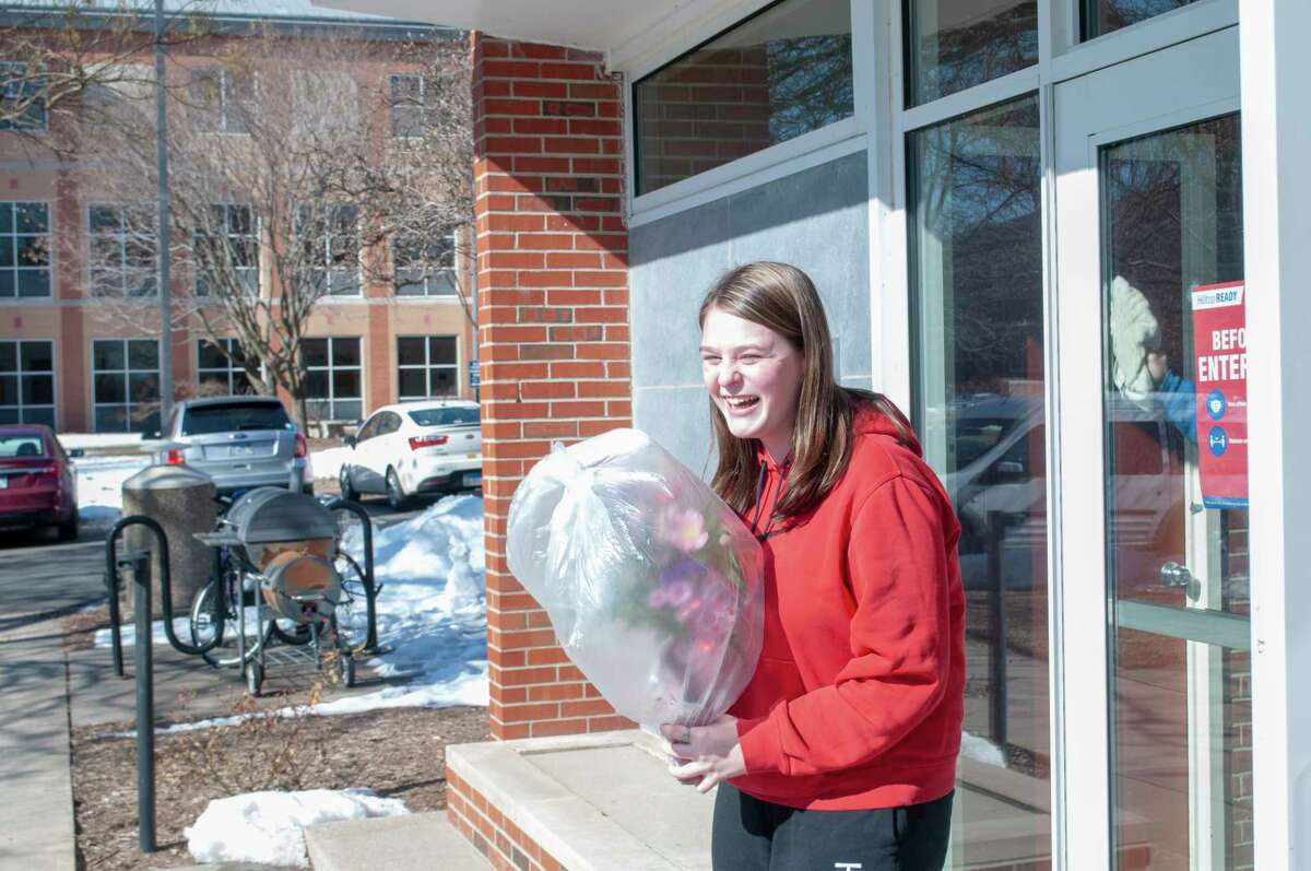 Illinois College student Abigail Beddingfield is surprised Monday with flowers delivered by Mike Chumley of All Occasions Flowers and Gifts. Beddingfield's flowers were just one of around 100 deliveries Chumley expected to make on Valentine's Day. Together, All Occasions drivers made around 400 deliveries. To view more delivery photos, visit myjournalcourier.com.