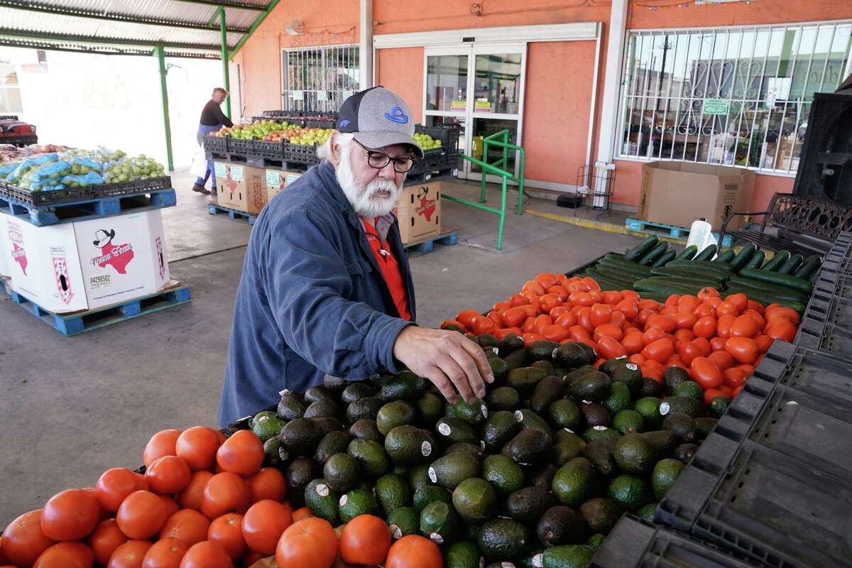 Gilbert Weaver, operations manager at Chicho Boys Fruit Market, stocks avocados Monday afternoon. On Saturday, the United States suspended imports of Mexican avocados.
