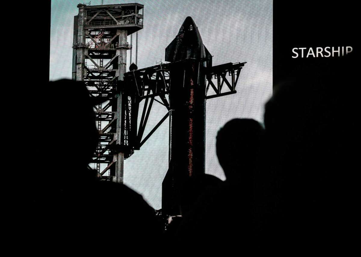 People listen as Elon Musk, founder of SpaceX, speaks during a Starship update press conference Thursday, Feb. 10, 2022, at a SpaceX facility in Boca Chica.