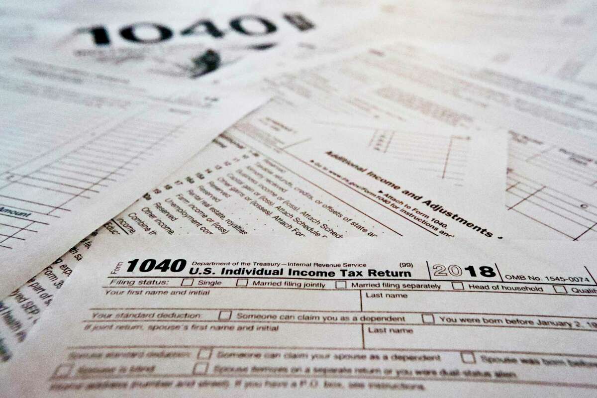 Low-income San Franciscans can get free tax help from the city starting next month, with families potentially eligible to get hundreds or even thousands back in tax credits, refunds and federal relief payments. This Feb. 13, 2019 file photo shows multiple forms printed from the Internal Revenue Service web page. (AP Photo/Keith Srakocic)