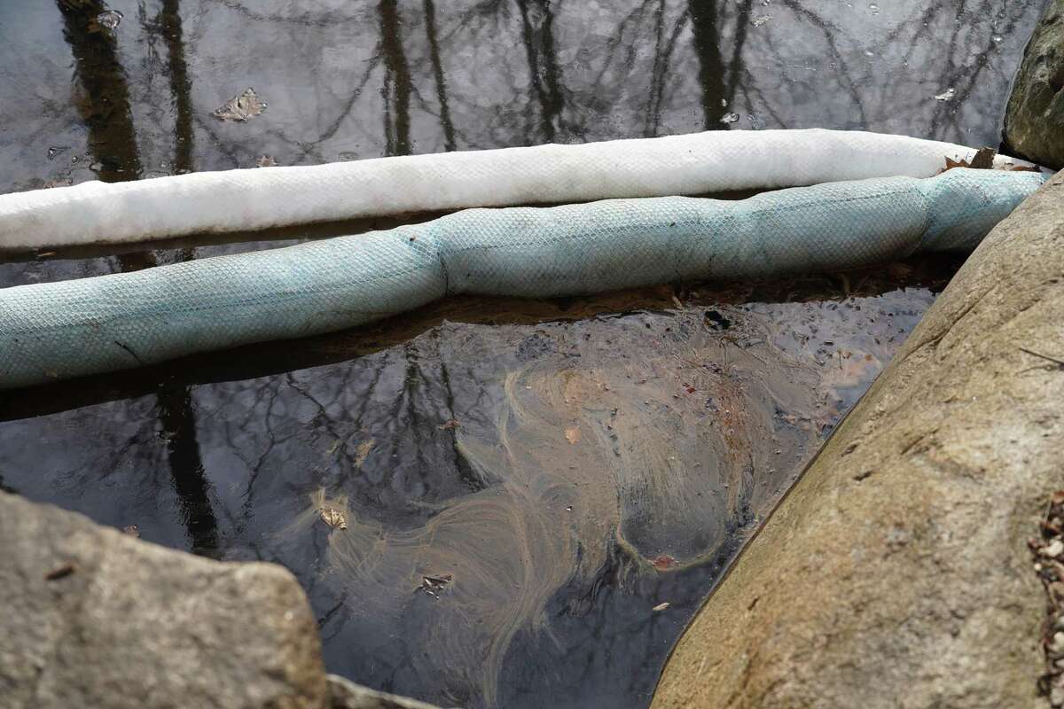 Absorbent booms were installed to stem the flow of oil coming from a leak of a 275-gallon residential oil tank that contaminated Bristow Sanctuary in New Canaan. The pond sits on the edge of the 16.8-acre nationally renowned park, which the town has spend over $200,000 to restore. Photos were taken Feb. 12, 2022.