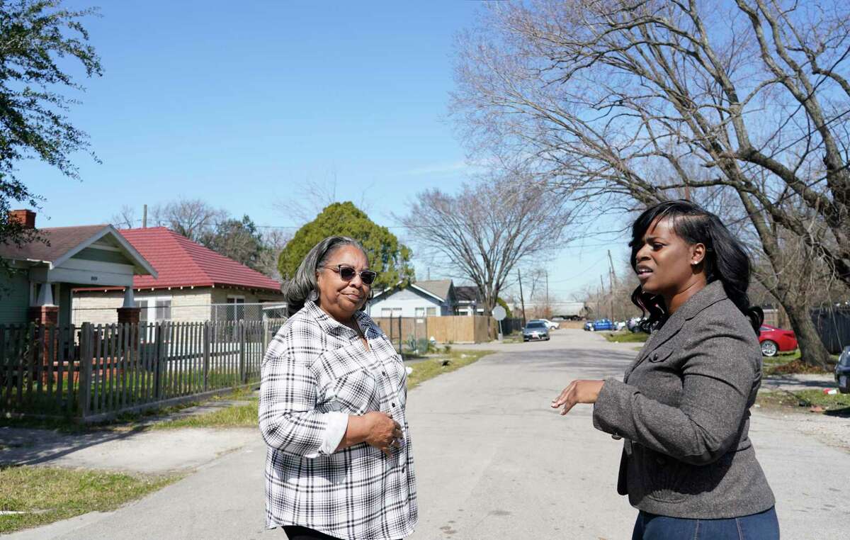 Kathy Blueford-Daniels, left, and Kendra London, right, both Fifth Ward residents and community activists, talk about health concerns in the area from the creosote contamination at the former Union Pacific Railroad site wood treatment facility shown Monday, Feb. 14, 2022, in Houston. Residents had previously picketed at the contaminated rail yard on Valentine’s Day, but Kendra London said she was so frustrated and tired of fighting.