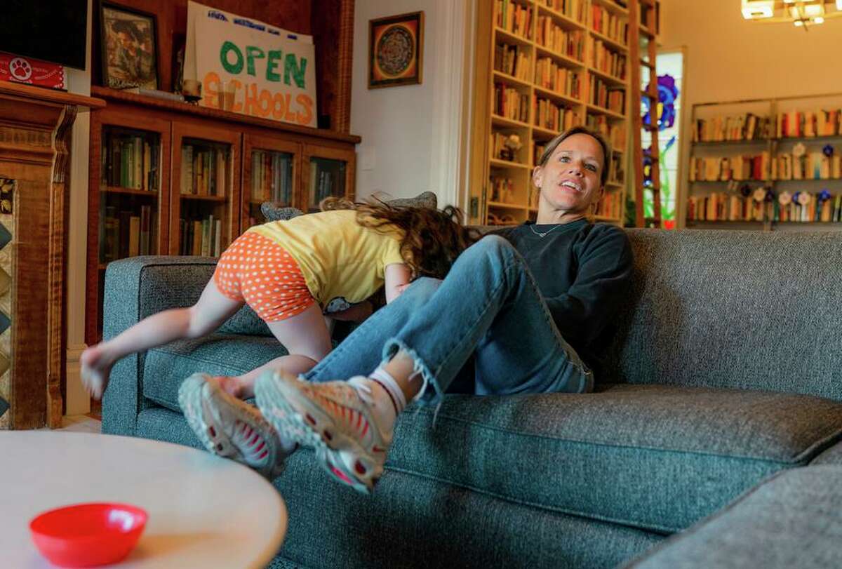 Former Levi’s executive Jennifer Sey sits with her daughter, Ruth, while at their home in San Francisco in 2020.