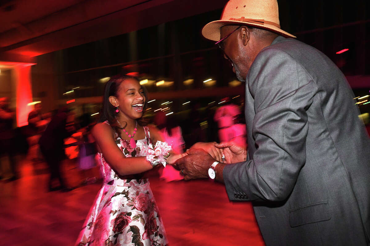 Tay'Lyn Plesant and godfather Ricky Wilridge enjoy the City of Beaumont's Daddy Daughter Dance at the Event Centre Friday night. Photo made Friday, February 11, 2022 Kim Brent/The Enterprise