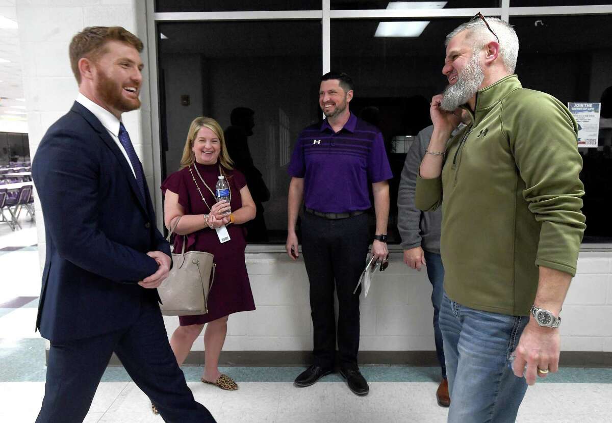 Jeff Joseph is congratulated by board members, including Scott Bartlett (right), at meeting end after being approved by the Port Neches-Groves school board as the new football coach and athletic director, replacing Brandon Faircloth, who announced his resignation from the position months ago. Photo made Monday, February 14, 2022 Kim Brent/The Enterprise