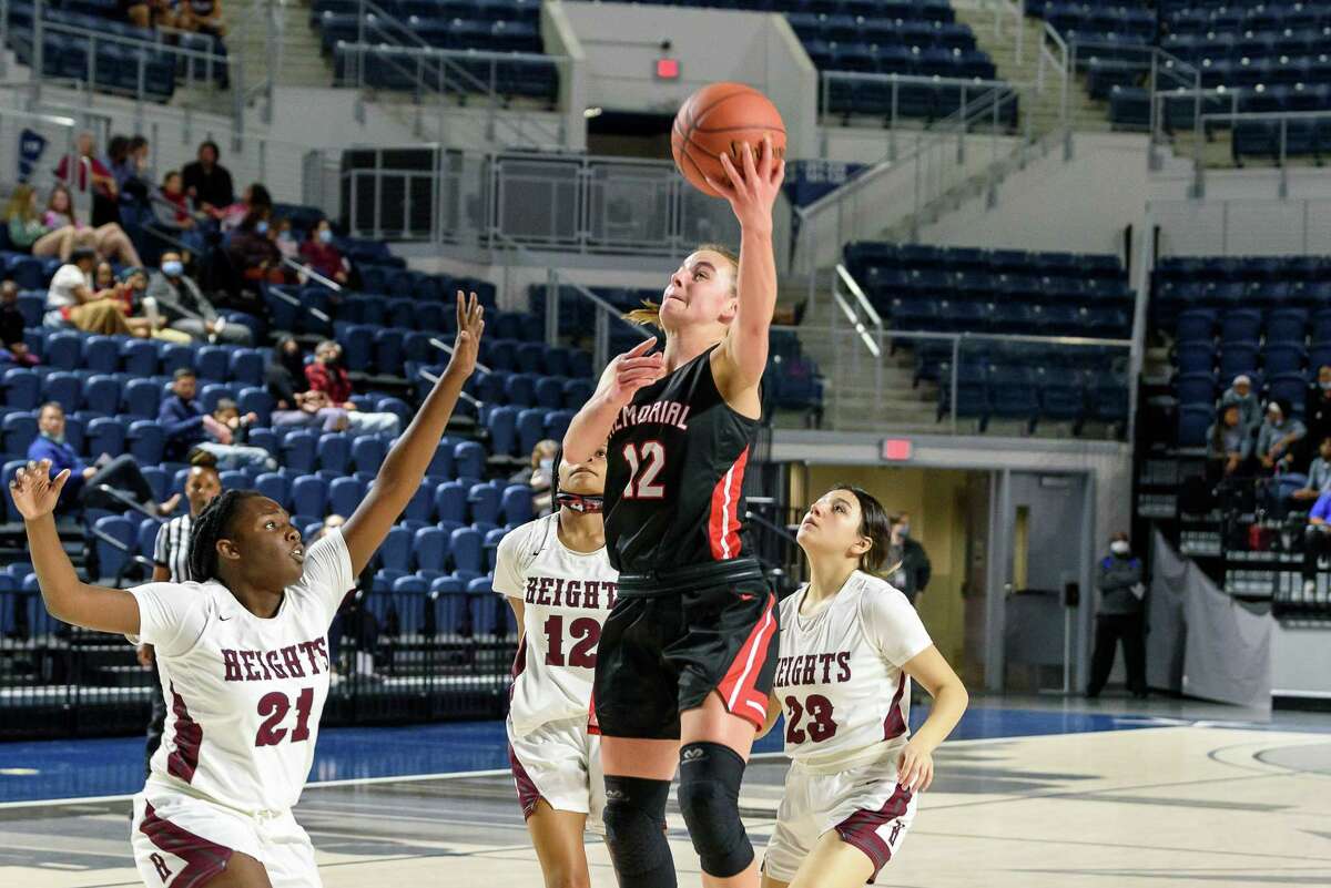 Memorial's Abigail Tomaski shoots a layup during the Lady Mustangs' bi-district playoff game against Heights at Delmar Stadium on Feb. 14, which Memorial would win 81-35.
