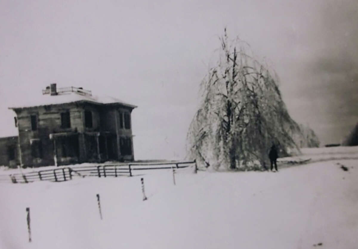 Pictured is a house in Chase with a tree in the yard weighed down with ice during the Feb. 22, 1922, storm.