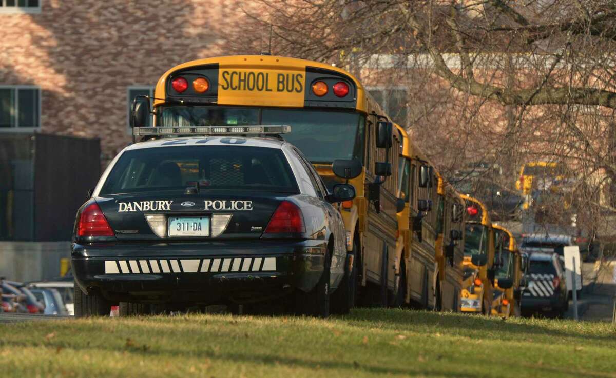 Danbury Police cruisers parked at Danbury High School on Monday, November 25, 2019, in Danbury, Conn. Several schools, not including Danbury High School were placed on lockdown on Tuesday, Feb. 15, 2022 as police searched for a person they believed had a handgun.