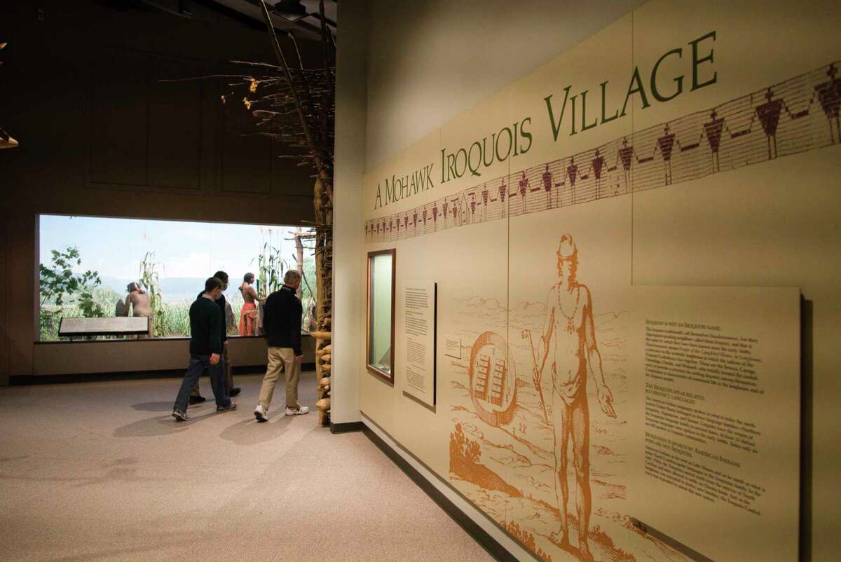 Visitors to the New York State Museum walk through the exhibit on the Haudenosaunee, who the Iroquois traditionally call themselves, in the First Peoples gallery on Tuesday, Feb. 15, 2022, in Albany, N.Y.