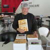 Dr. Betty Jones poses with her newest book, "Pass It On," at Midland Center for the Arts on Monday, Feb. 14.