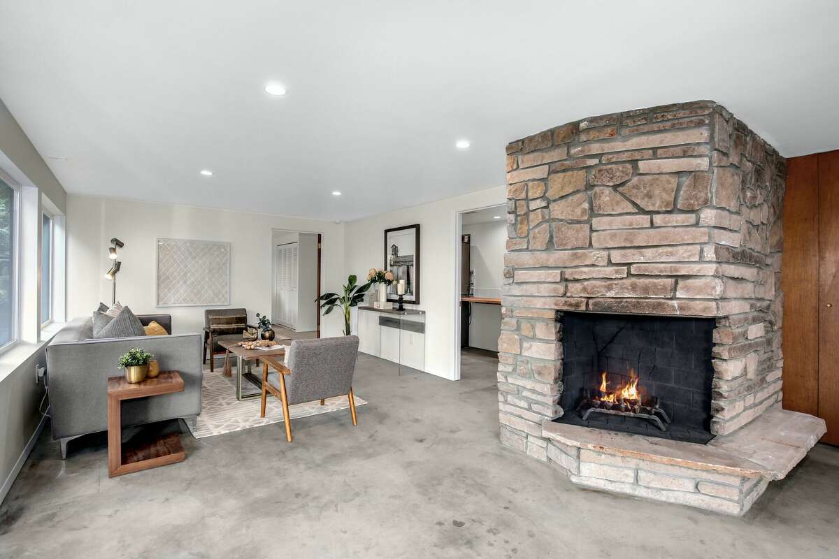 Mid-century homes often have lower levels used for entertaining and convivial family living.  Here, the ground floor is warmed by another original fireplace. 